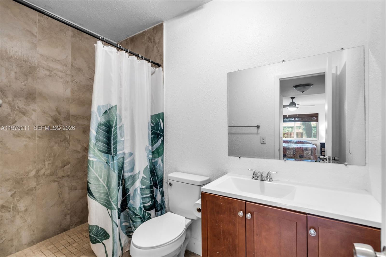 3785 Raleigh Street Hollywood, FL 33021 - Photo 16 of 36 a bathroom with a granite countertop sink a toilet and mirror