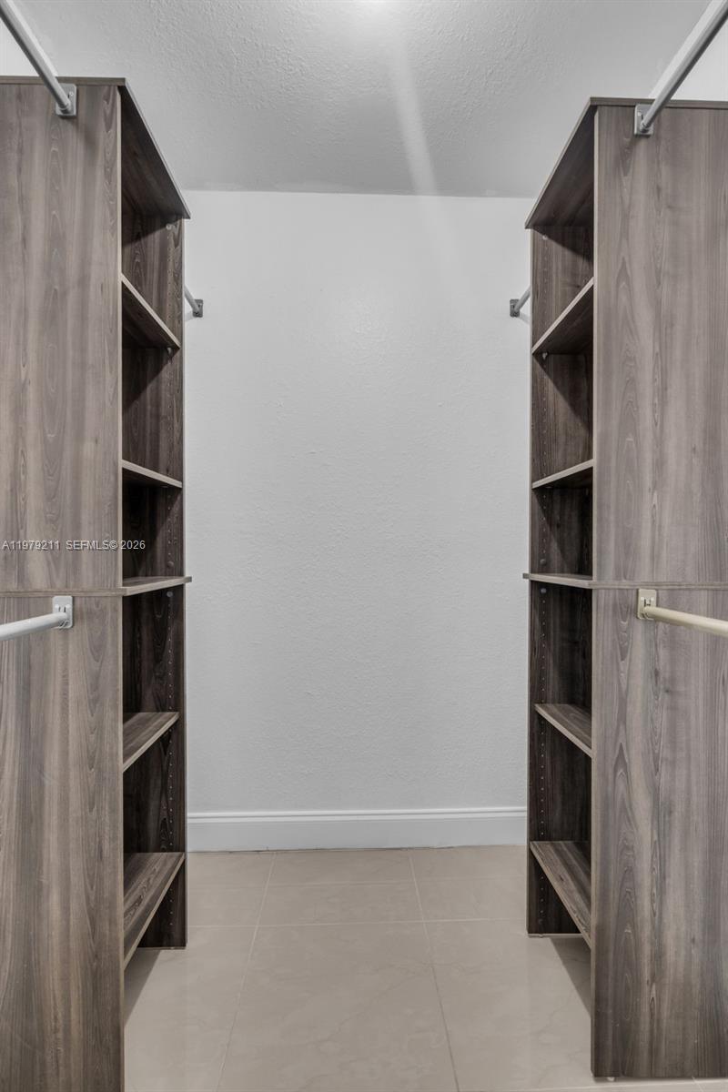3785 Raleigh Street Hollywood, FL 33021 - Photo 18 of 36 a view of walk in closet with empty racks
