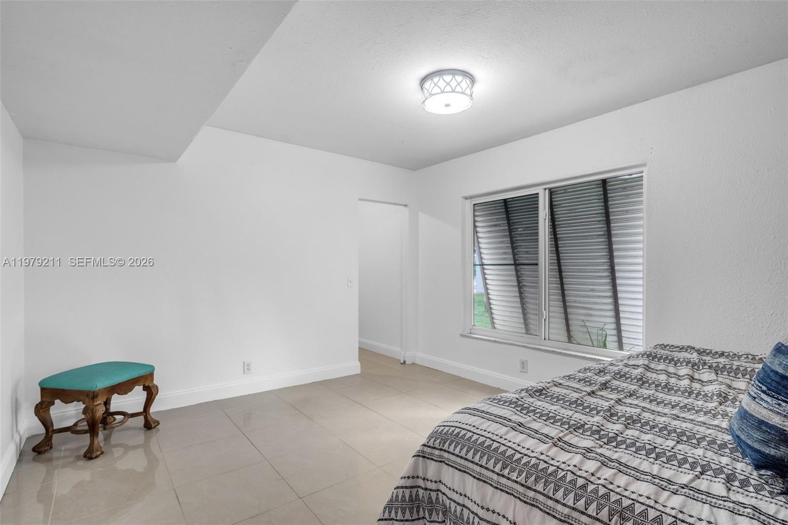 3785 Raleigh Street Hollywood, FL 33021 - Photo 19 of 36 a bedroom with a bed and a chair