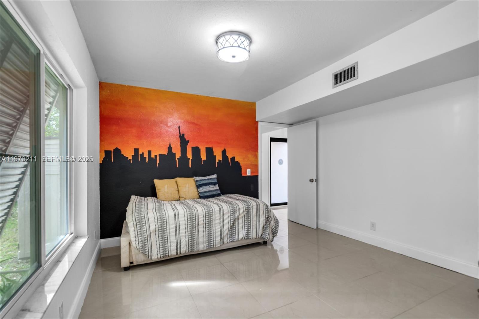 3785 Raleigh Street Hollywood, FL 33021 - Photo 20 of 36 a bedroom with a bed and a large window