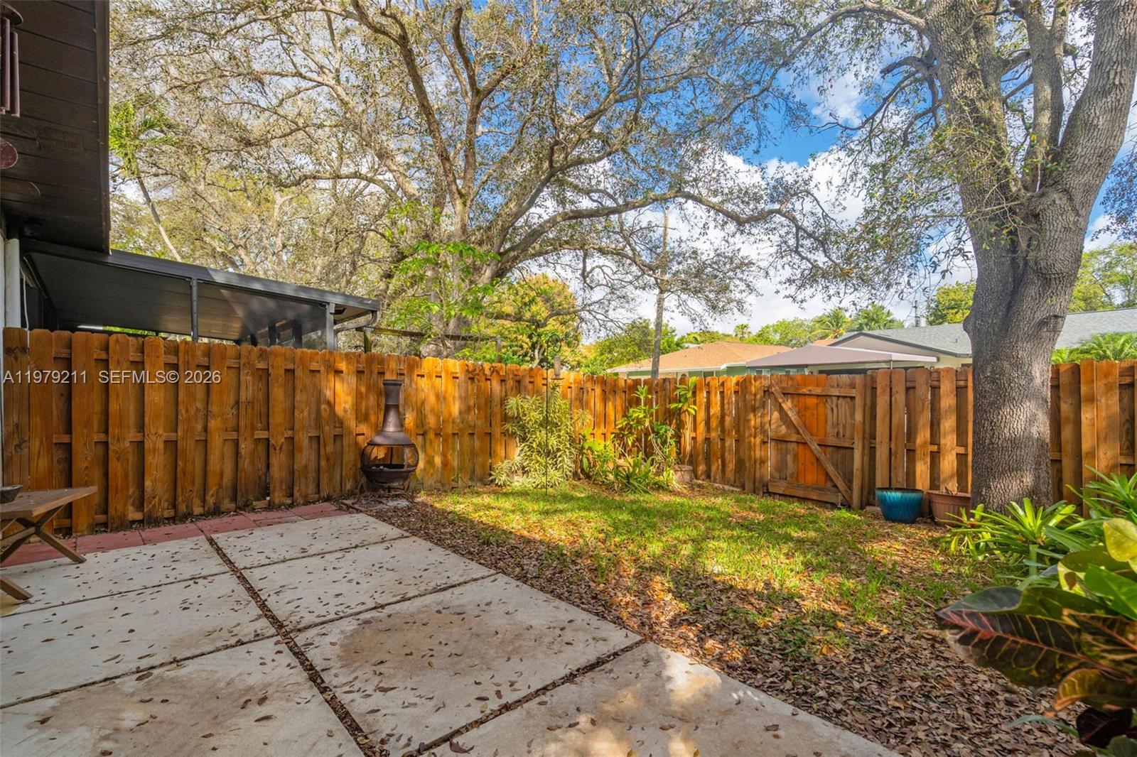 3785 Raleigh Street Hollywood, FL 33021 - Photo 26 of 36 a view of a backyard with wooden fence