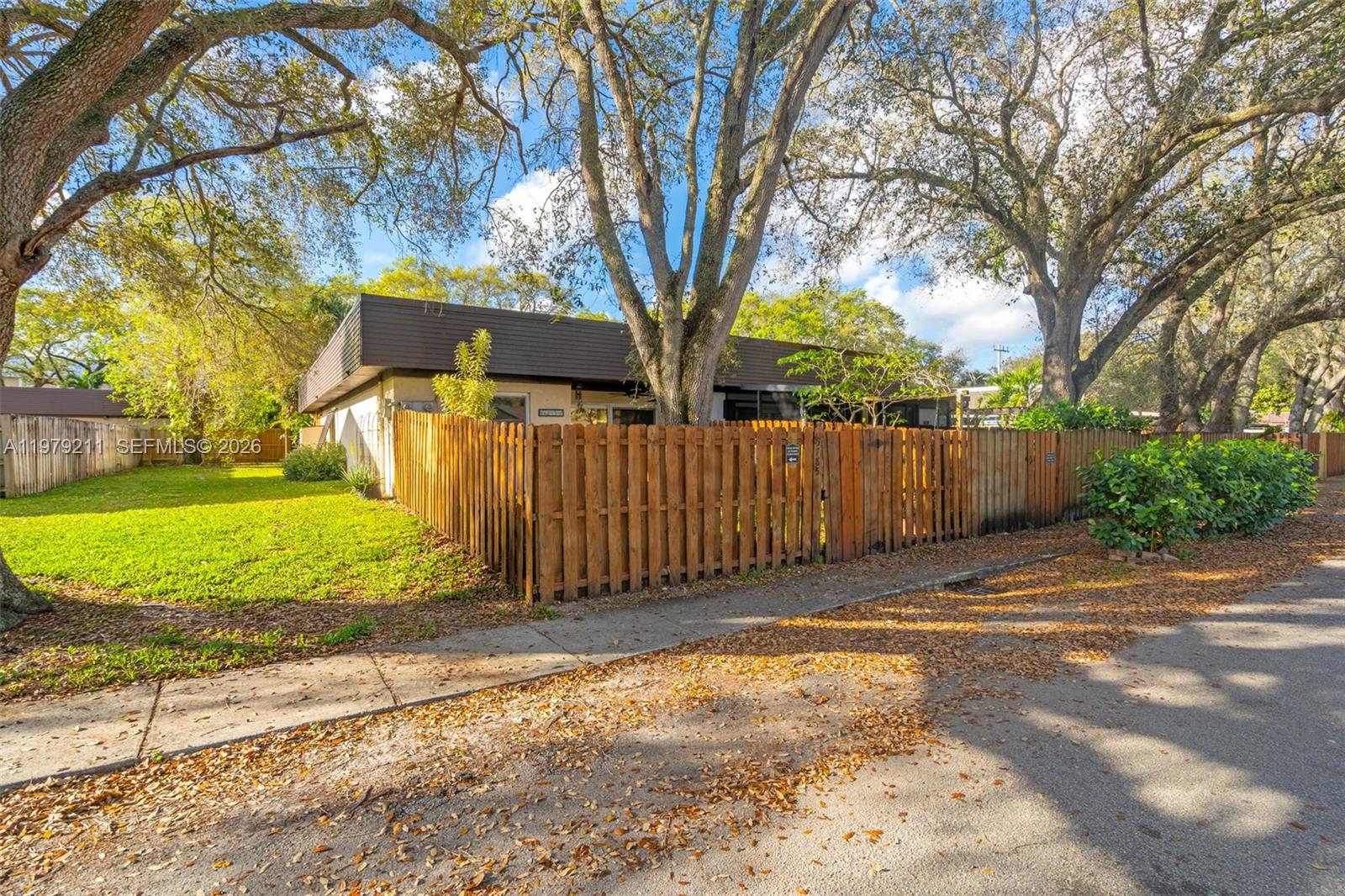 3785 Raleigh Street Hollywood, FL 33021 - Photo 28 of 36 a view of a yard with wooden fence