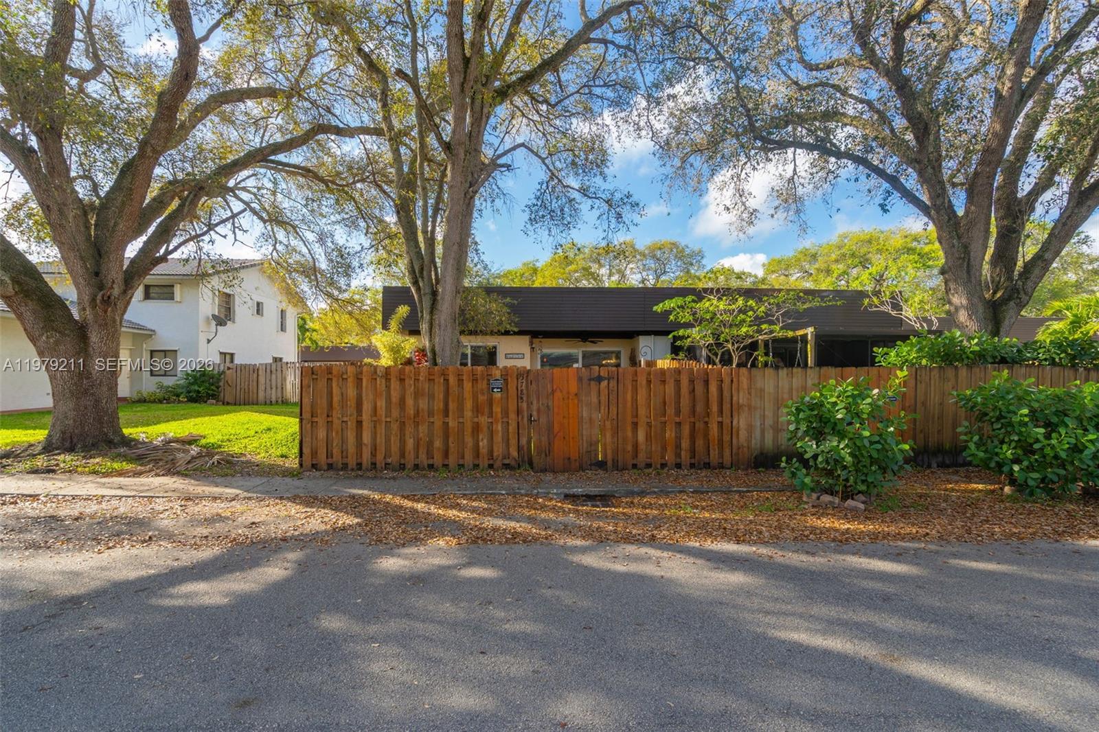3785 Raleigh Street Hollywood, FL 33021 - Photo 29 of 36 a view of a backyard with a large tree