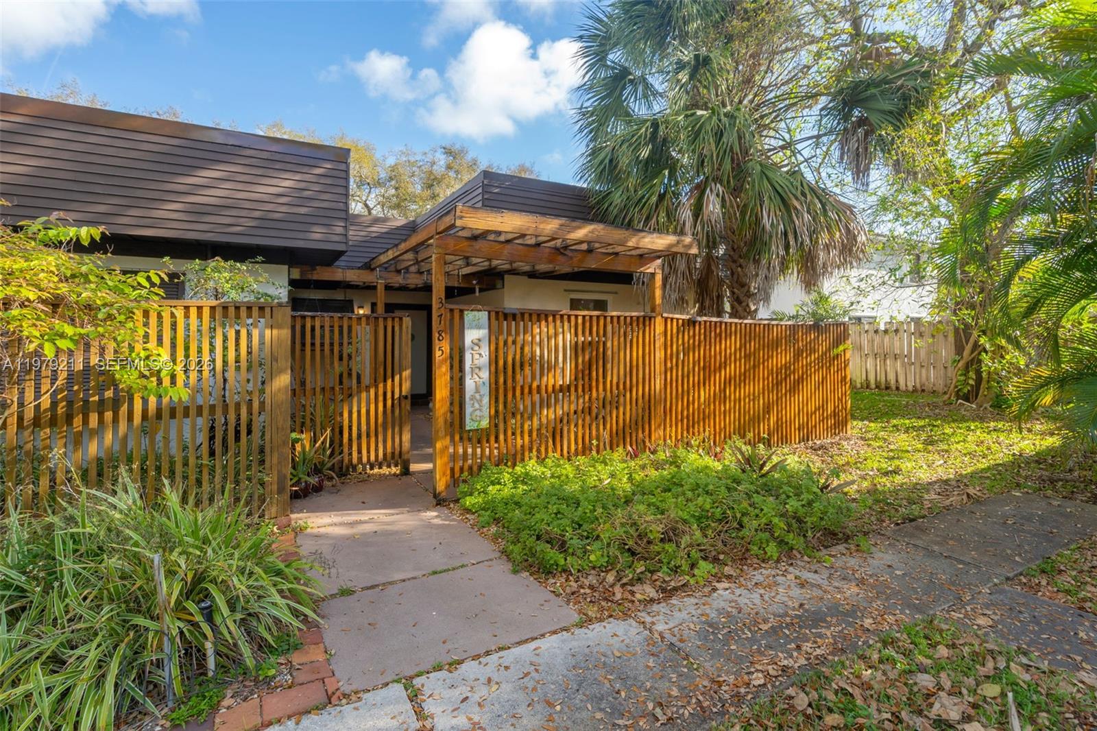 3785 Raleigh Street Hollywood, FL 33021 - Photo 31 of 36 a view of a house with a large window and potted plants