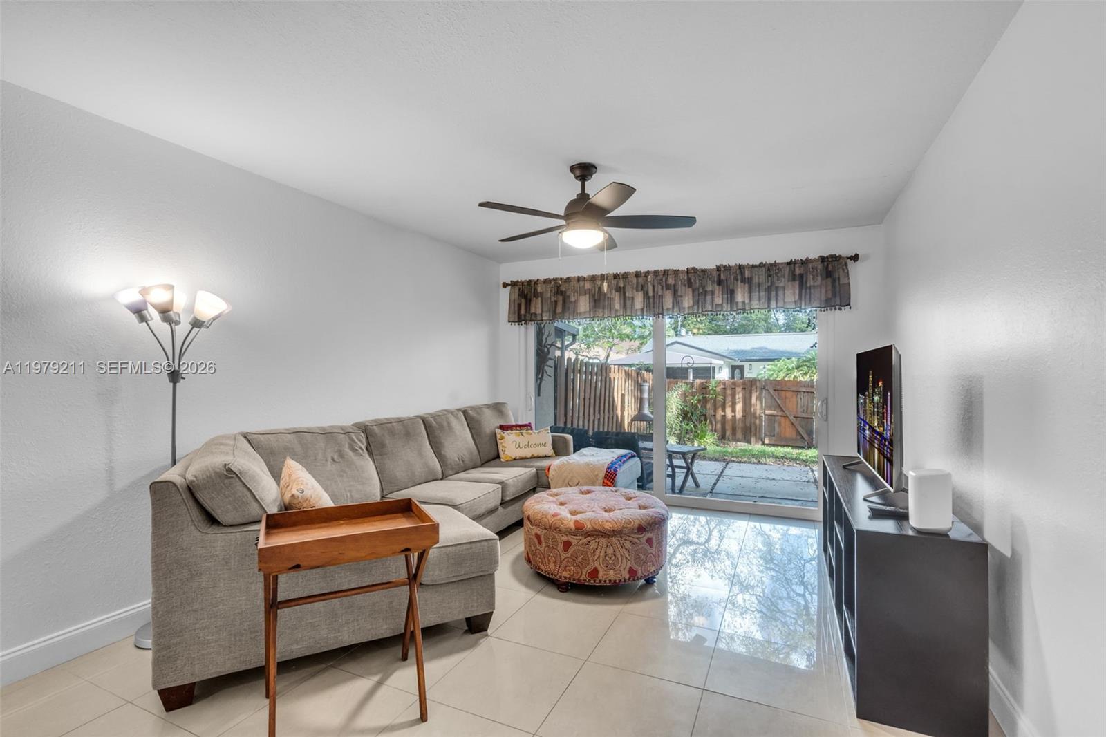 3785 Raleigh Street Hollywood, FL 33021 - Photo 6 of 36 a living room with furniture and a large window