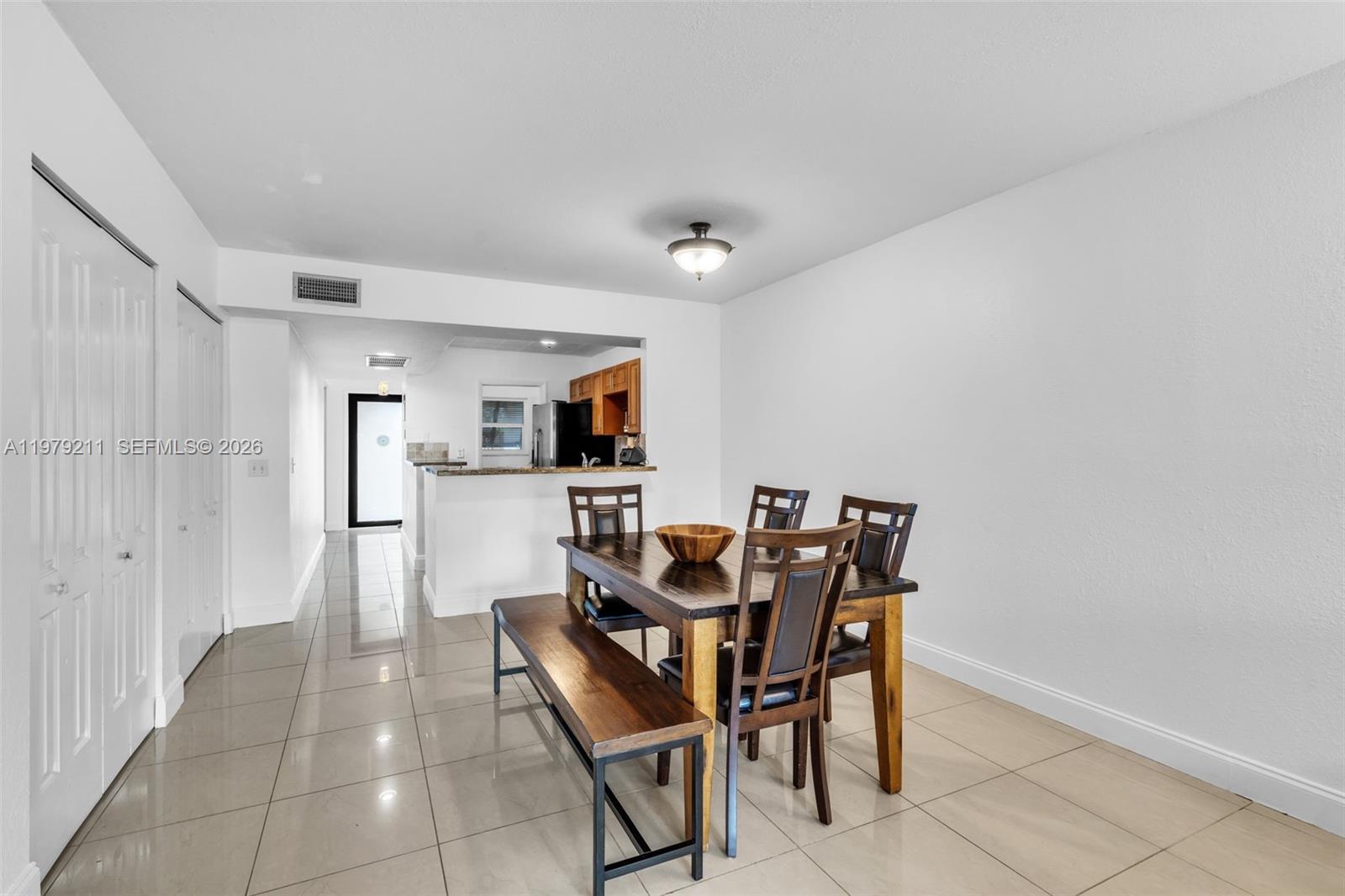 3785 Raleigh Street Hollywood, FL 33021 - Photo 8 of 36 a dining room with furniture and kitchen view