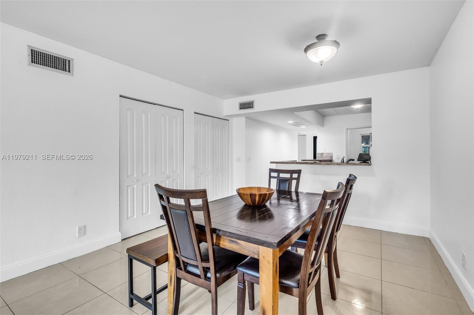3785 Raleigh Street Hollywood, FL 33021 - Photo 10 of 36 a view of a dining room and livingroom with furniture and wooden floor