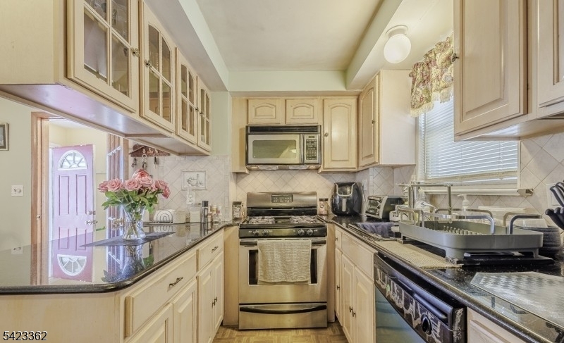 66 Garrison Street Newark, NJ 07105 - Photo 14 of 25 a kitchen with stainless steel appliances a stove a sink and a microwave