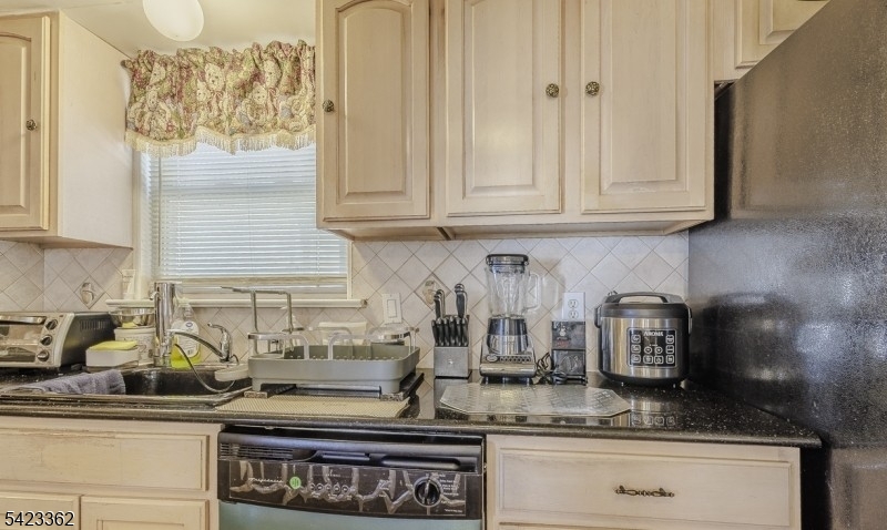 66 Garrison Street Newark, NJ 07105 - Photo 15 of 25 a kitchen with stainless steel appliances granite countertop white cabinets and a stove top oven