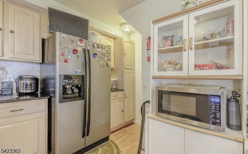 66 Garrison Street Newark, NJ 07105 - Photo 16 of 25 a kitchen with stainless steel appliances a stove a refrigerator and cabinets