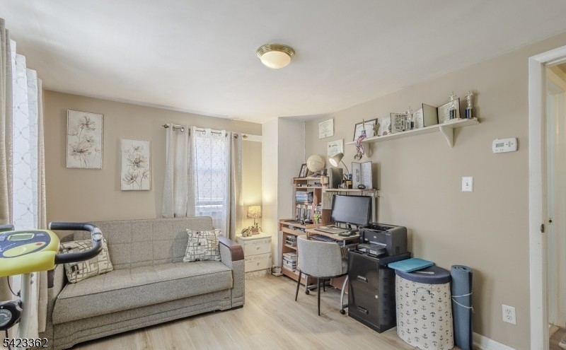 66 Garrison Street Newark, NJ 07105 - Photo 18 of 25 a living room with furniture and a window