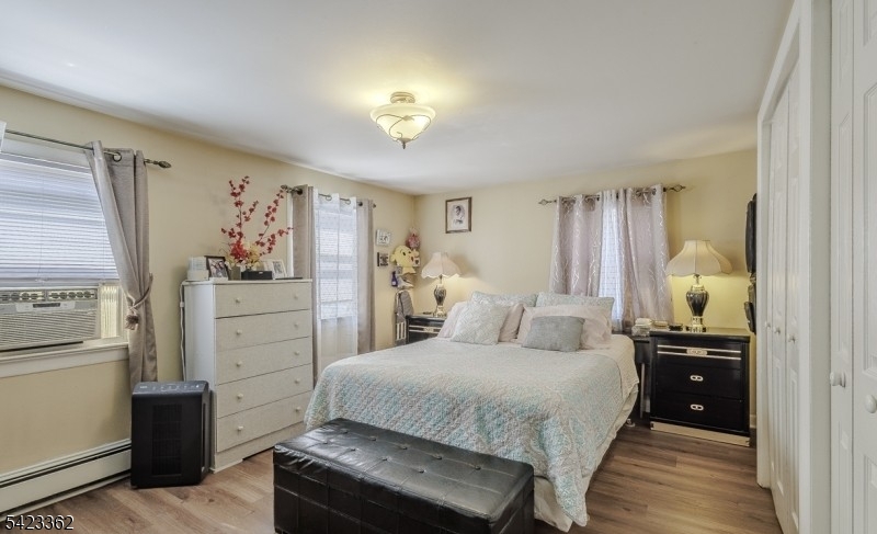 66 Garrison Street Newark, NJ 07105 - Photo 21 of 25 a bedroom with a bed and a chandelier