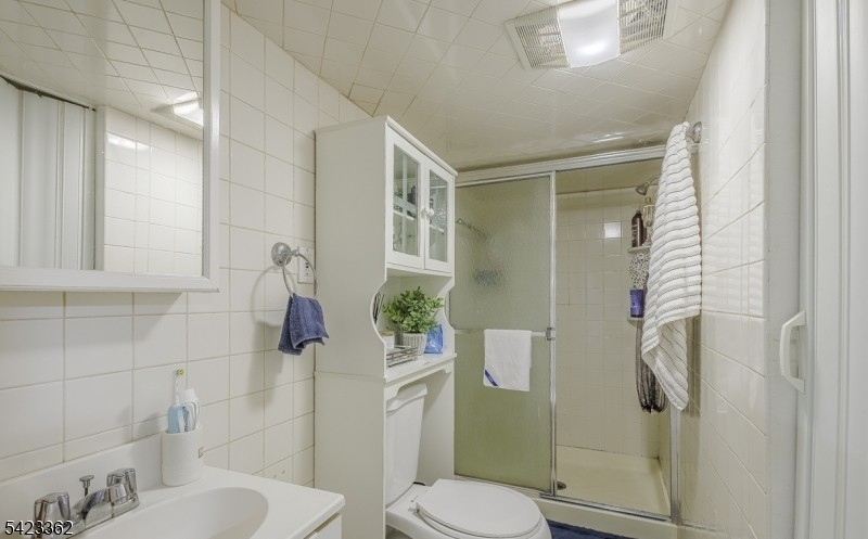 66 Garrison Street Newark, NJ 07105 - Photo 24 of 25 a white toilet sitting next to a bathroom sink