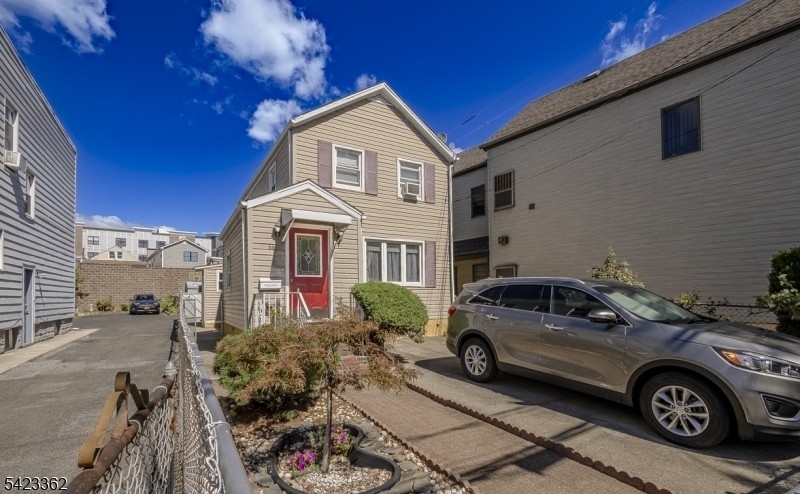 66 Garrison Street Newark, NJ 07105 - Photo 3 of 25 a front view of a house with parking space