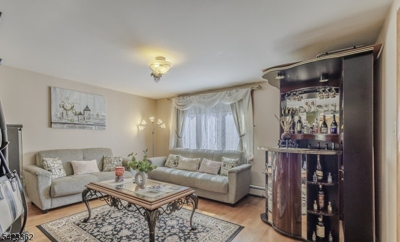 66 Garrison Street Newark, NJ 07105 - Photo 6 of 25 a living room with furniture and a window