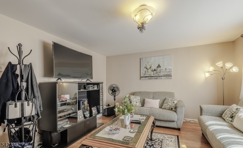 66 Garrison Street Newark, NJ 07105 - Photo 7 of 25 a living room with furniture a air conditioner and a flat screen tv