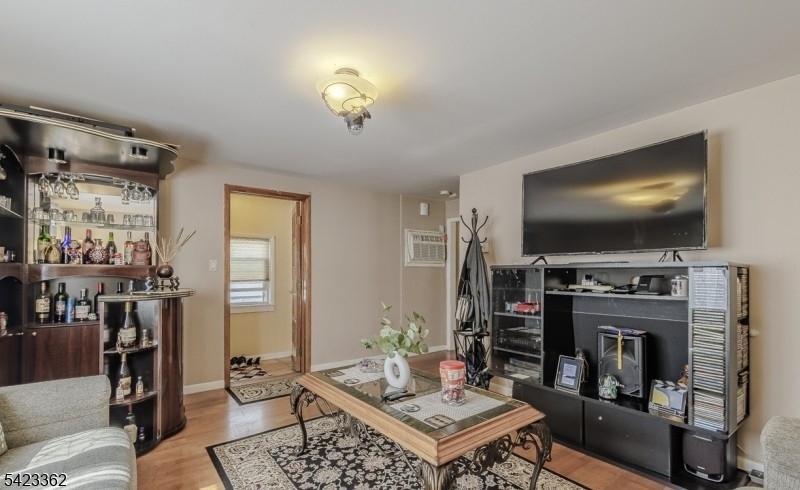 66 Garrison Street Newark, NJ 07105 - Photo 8 of 25 a living room with furniture and a flat screen tv