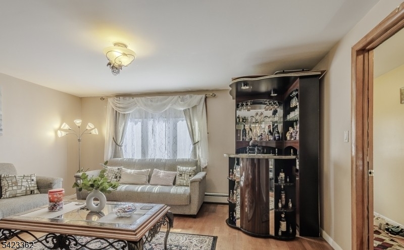 66 Garrison Street Newark, NJ 07105 - Photo 9 of 25 a living room with furniture and a window