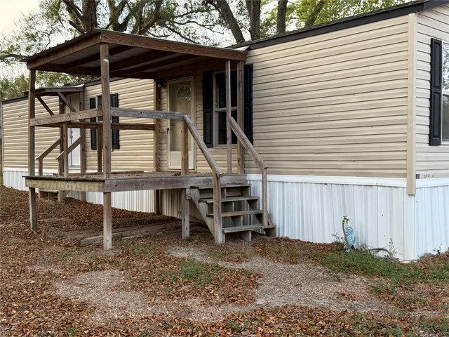 a view of a chairs and table in the backyard