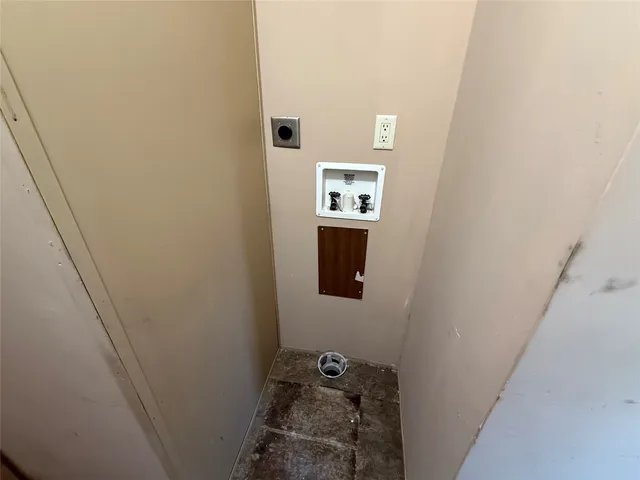 a view of a hallway with a door and stairs