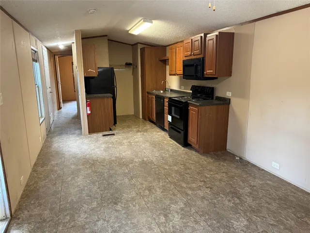 a kitchen with stainless steel appliances a refrigerator and a microwave