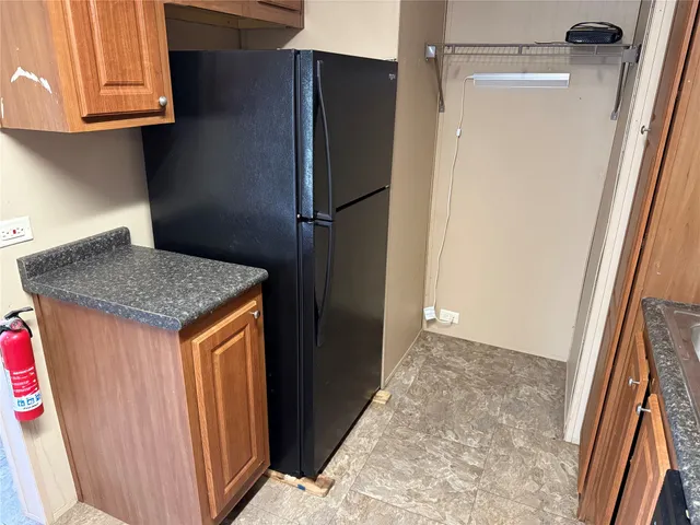 a kitchen with a refrigerator and cabinets