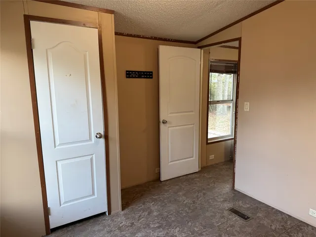 a view of an empty room and closet area