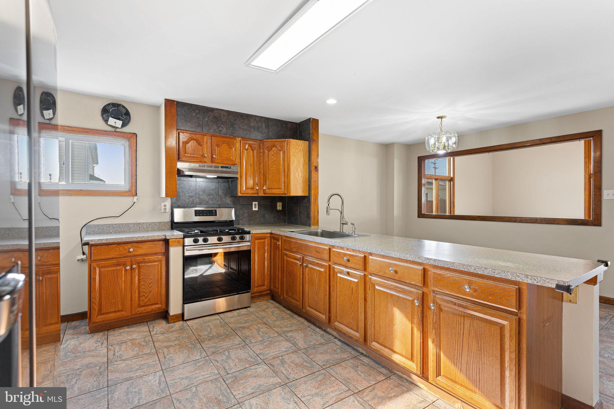 2623 Knights Road Bensalem, PA 19020 - Photo 15 of 50 a large white kitchen with stainless steel appliances granite countertop a stove top oven a sink and dishwasher