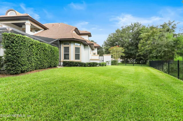 an aerial view of a house with a garden and swimming pool