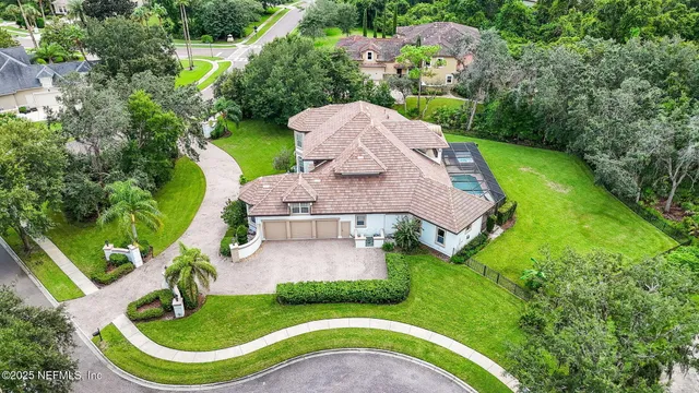 a view of a dining room with furniture a chandelier and wooden floor