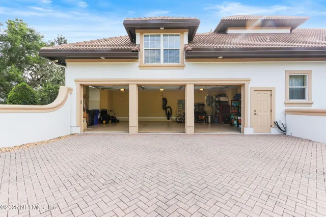 a kitchen with stainless steel appliances granite countertop a sink a stove and a wooden floors