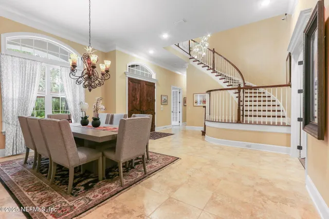 a living room with furniture a fireplace and a large window