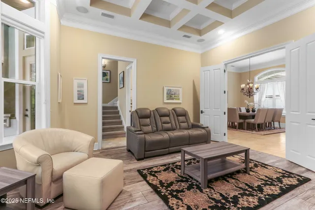 a bedroom with a bed and a flat tv screen on dresser