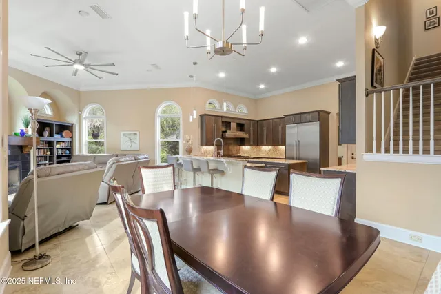 a bedroom with a bed a chandelier and a window