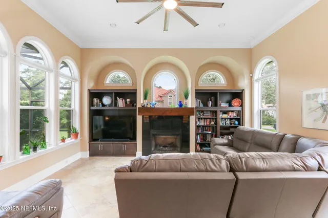 a living room with furniture pool table and a window