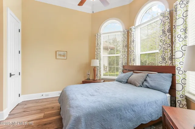 an aerial view of residential house with outdoor space and trees all around