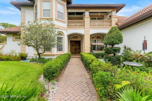 a front view of a house with yard and green space