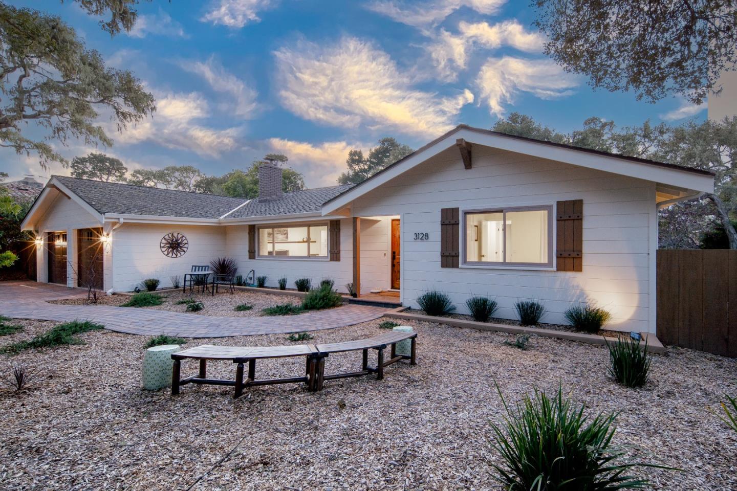 a view of a house with backyard and sitting area