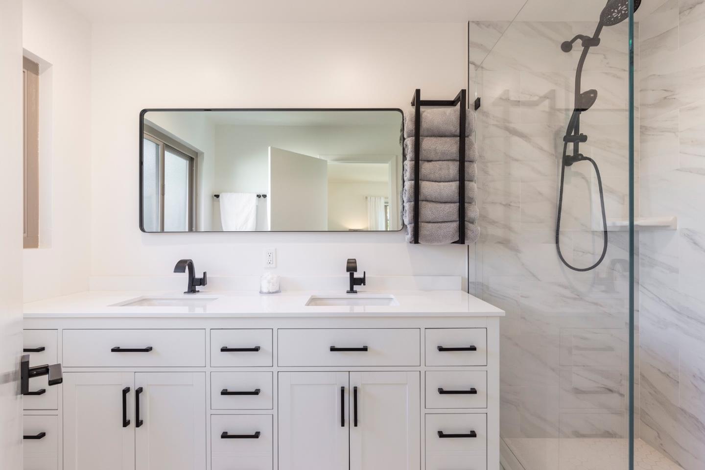 3128 Stevenson Drive Pebble Beach, CA 93953 - Photo 19 of 35 a bathroom with a double vanity sink and mirror