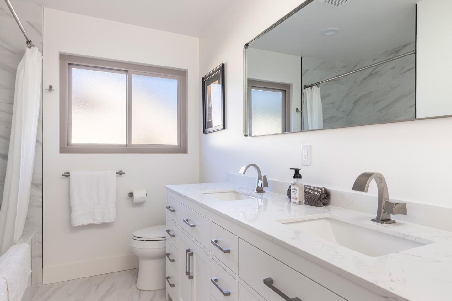 3128 Stevenson Drive Pebble Beach, CA 93953 - Photo 21 of 35 a bathroom with a double vanity sink toilet and mirror