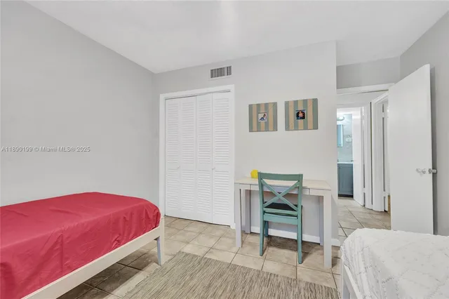 a bedroom with a bed and a chair