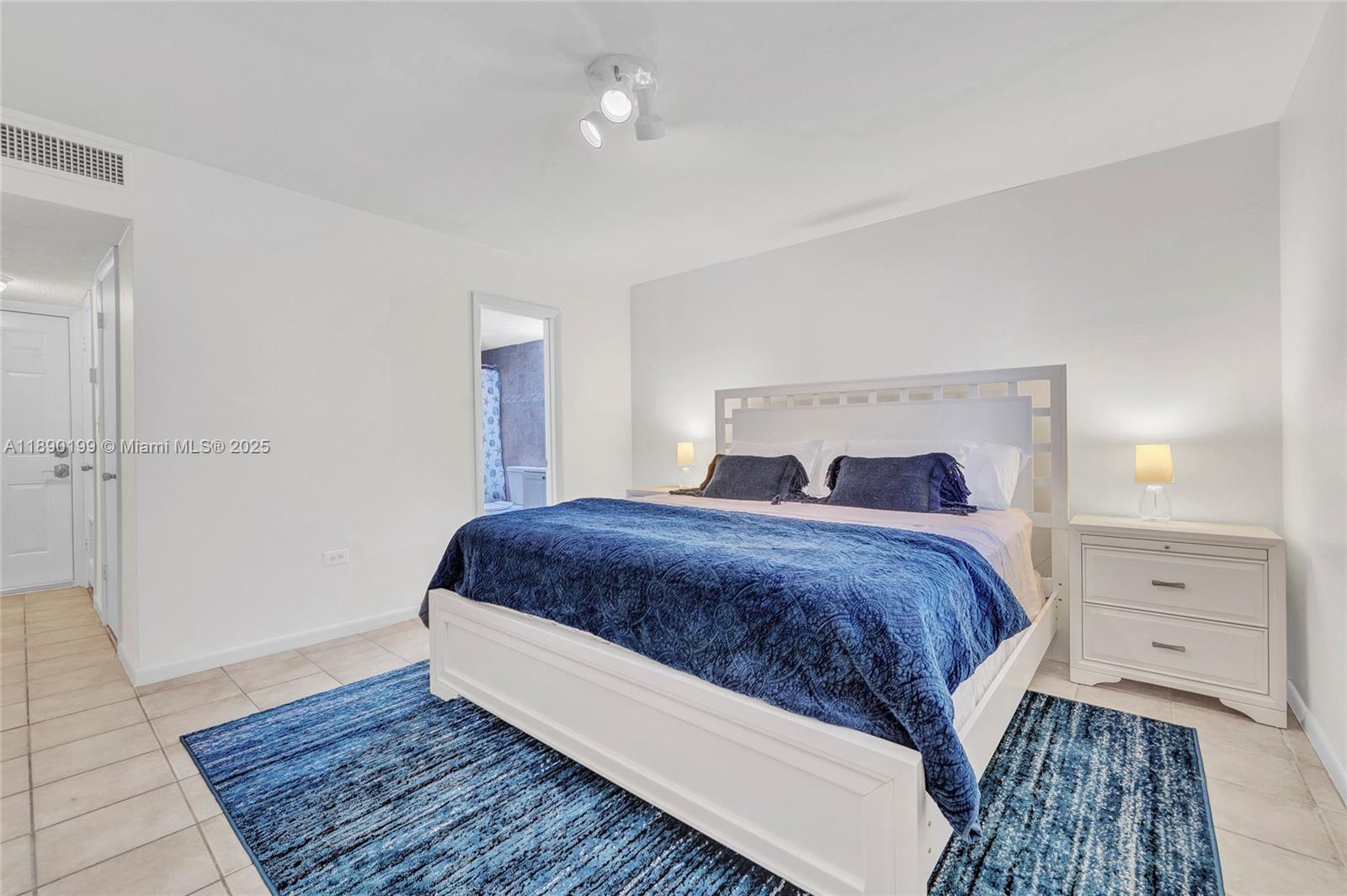 1129 Pebble Beach Lane, Unit 6 Marathon, FL 33050 - Photo 15 of 31 a bedroom with a bed and wooden floor