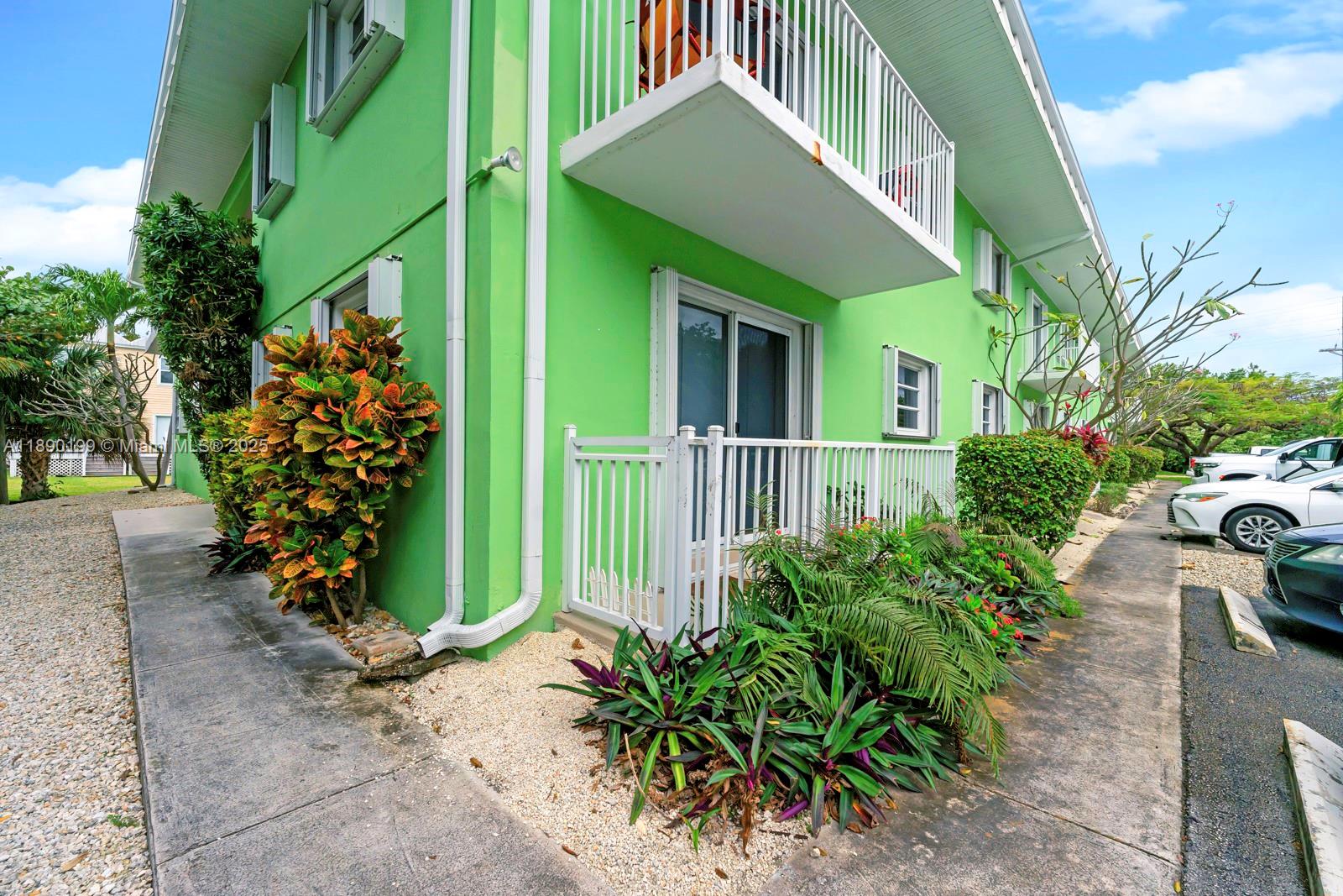 1129 Pebble Beach Lane, Unit 6 Marathon, FL 33050 - Photo 21 of 31 a front view of a house with a yard