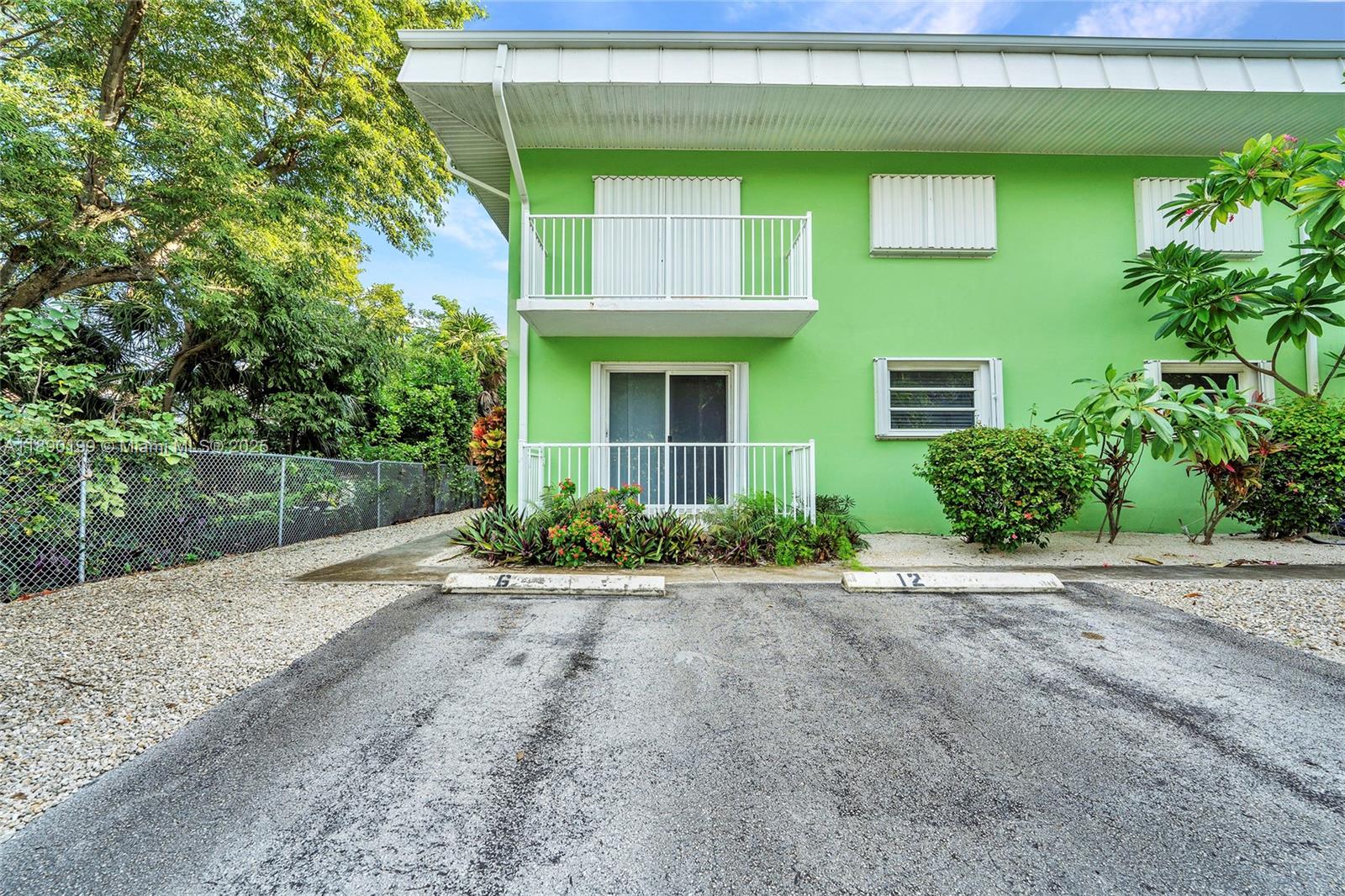 1129 Pebble Beach Lane, Unit 6 Marathon, FL 33050 - Photo 23 of 31 a front view of a house with a yard