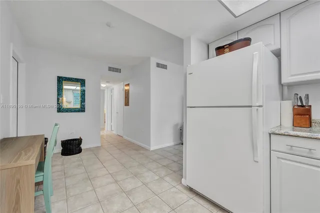 a white refrigerator freezer sitting in a kitchen