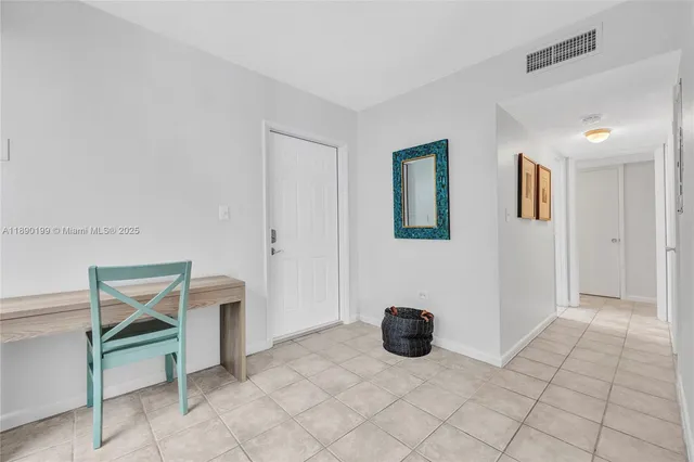 a view of a livingroom with furniture and an empty room