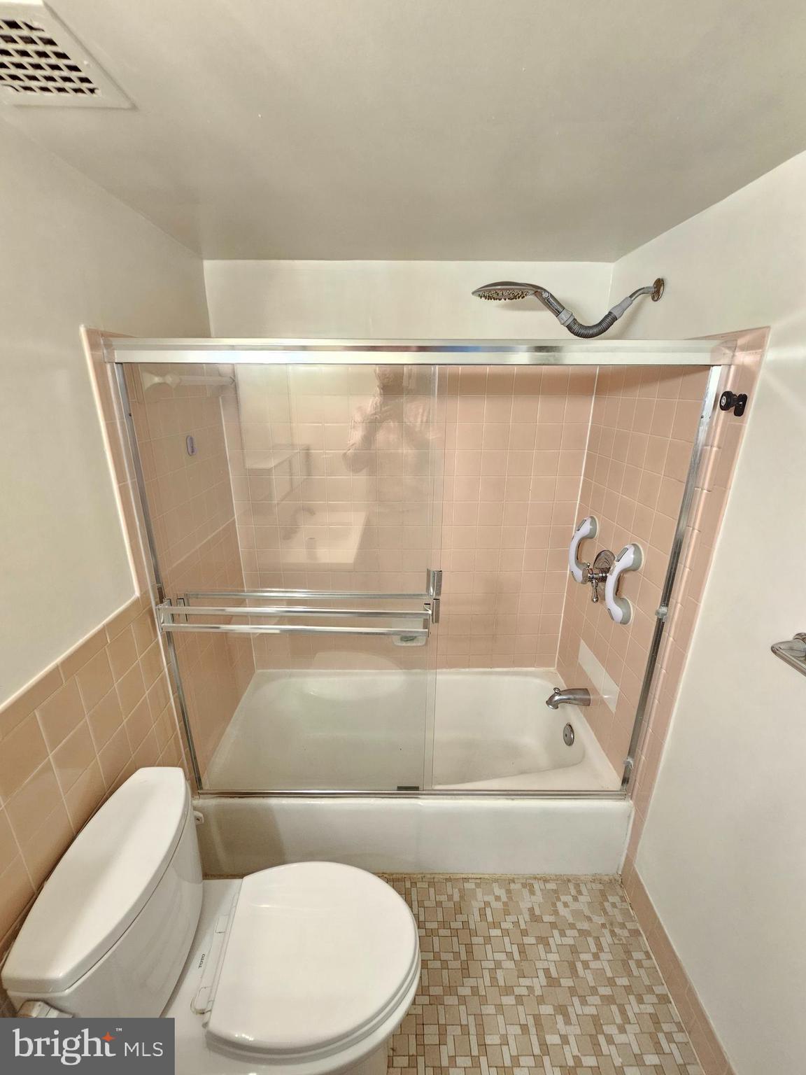 9900 Georgia Avenue, Unit 415 Silver Spring, MD 20902 - Photo 15 of 25 a bathroom with a toilet and a bathtub