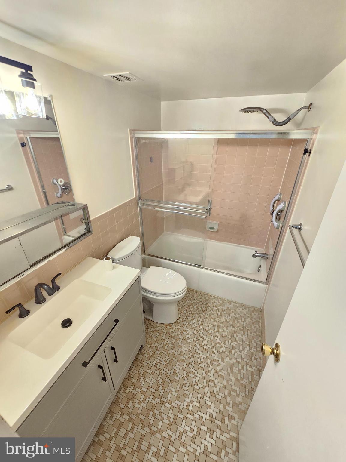 9900 Georgia Avenue, Unit 415 Silver Spring, MD 20902 - Photo 16 of 25 a bathroom with a sink toilet and shower