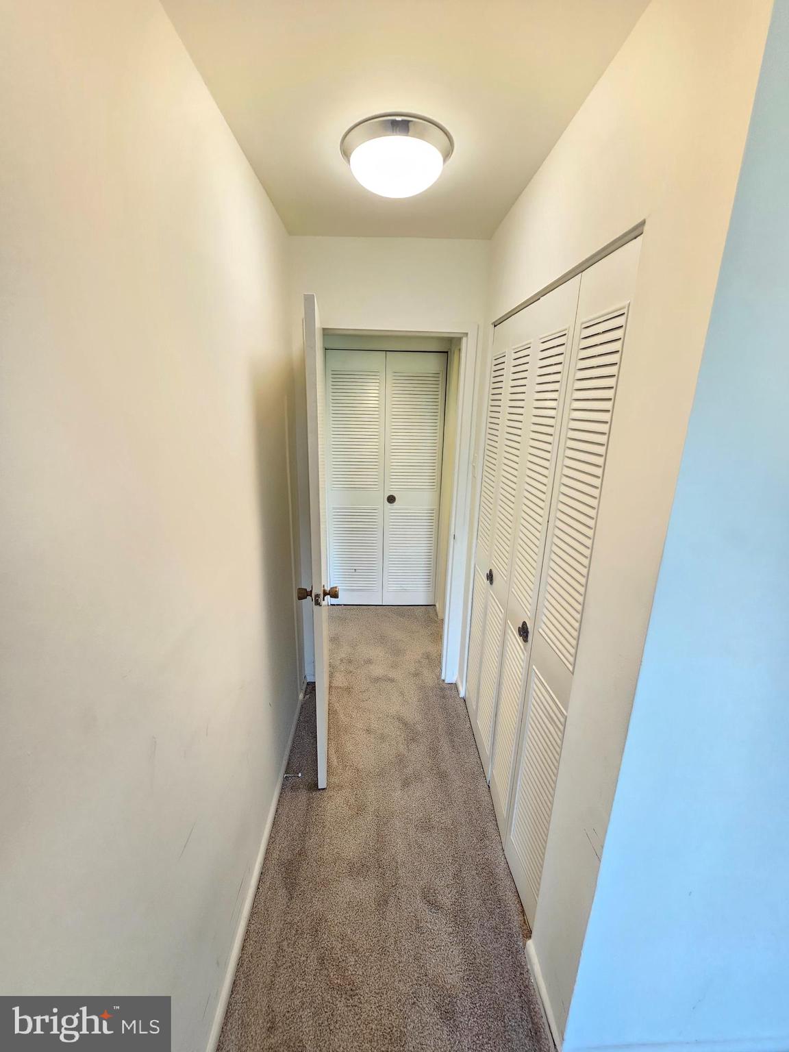 9900 Georgia Avenue, Unit 415 Silver Spring, MD 20902 - Photo 17 of 25 a view of a room with wooden floor and a ceiling fan