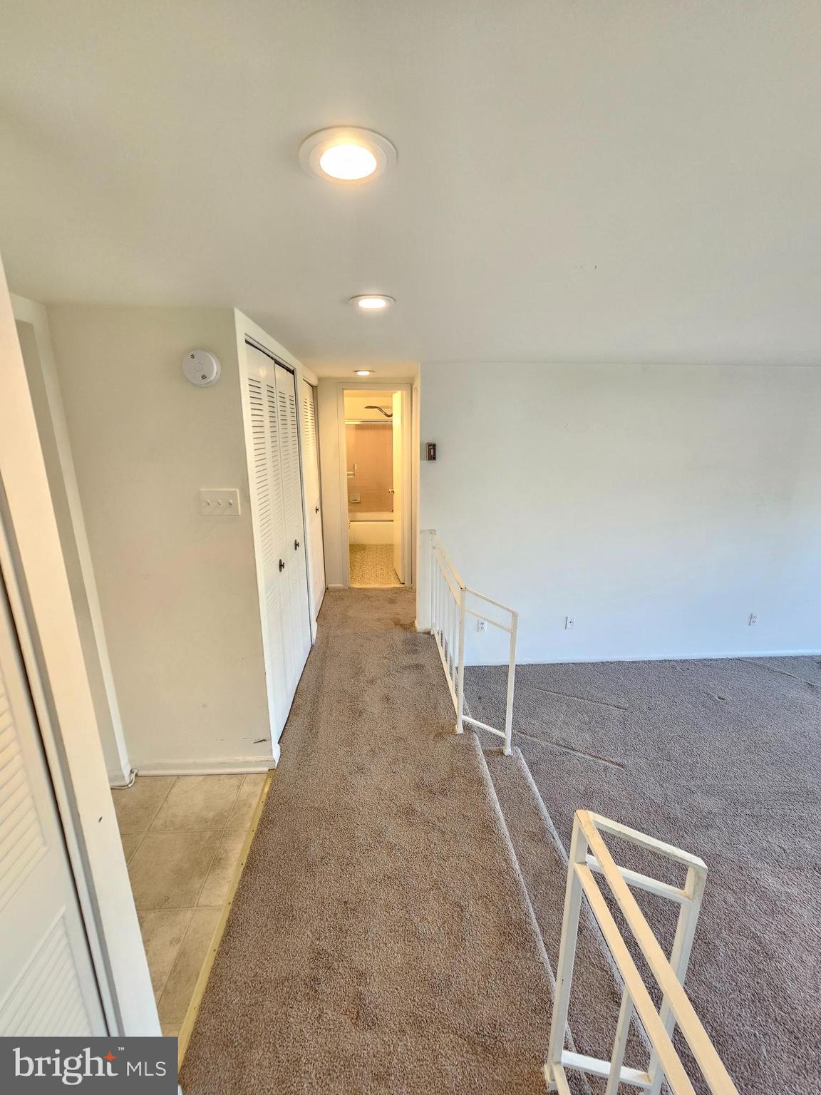 9900 Georgia Avenue, Unit 415 Silver Spring, MD 20902 - Photo 3 of 25 a view of a hallway with wooden floor and staircase